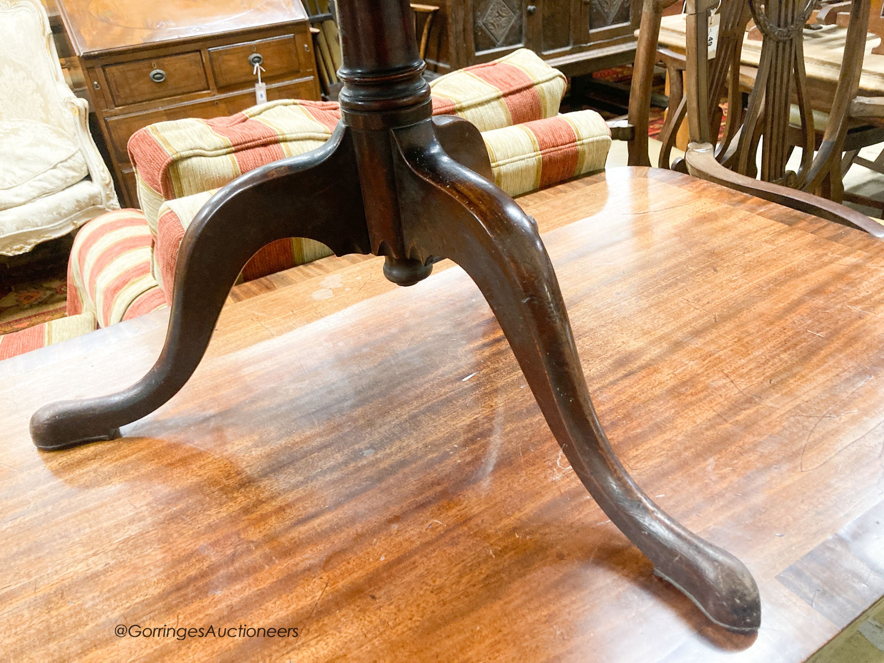 A George III mahogany drop flap two tier dumb waiter, diameter 56cm, height 77cm